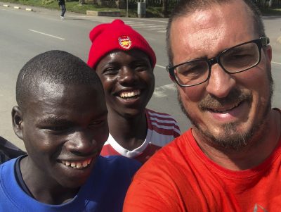 Photograph of Jamey Glasnovic with Valence and James, Musanze, Rwanda, 2019.